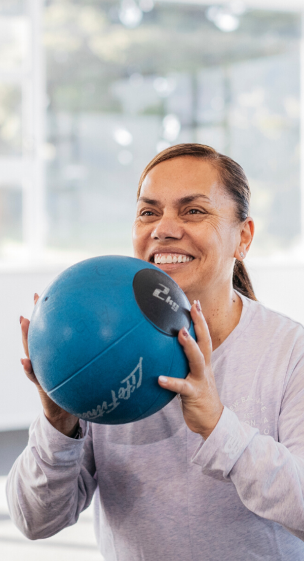 Side image women with medicine ball