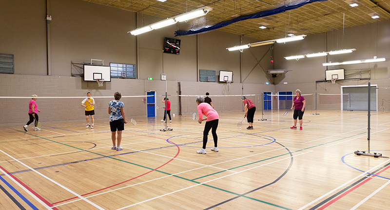 a group of adults playing badminton at the howick leisure centre