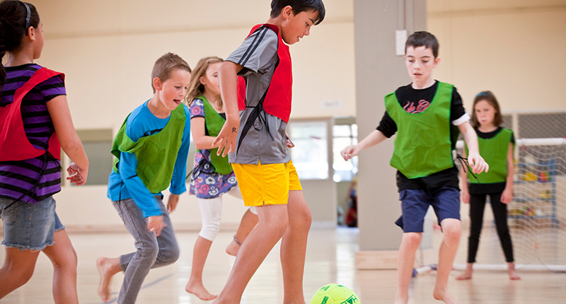 a group of children playing soccer