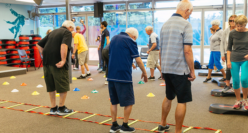 group of elderly people doing gentle exercises