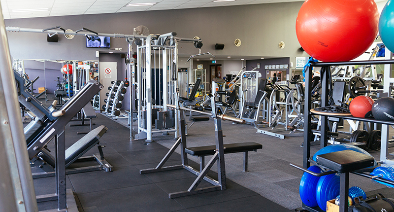 a fitness centre with weight machines and yoga balls