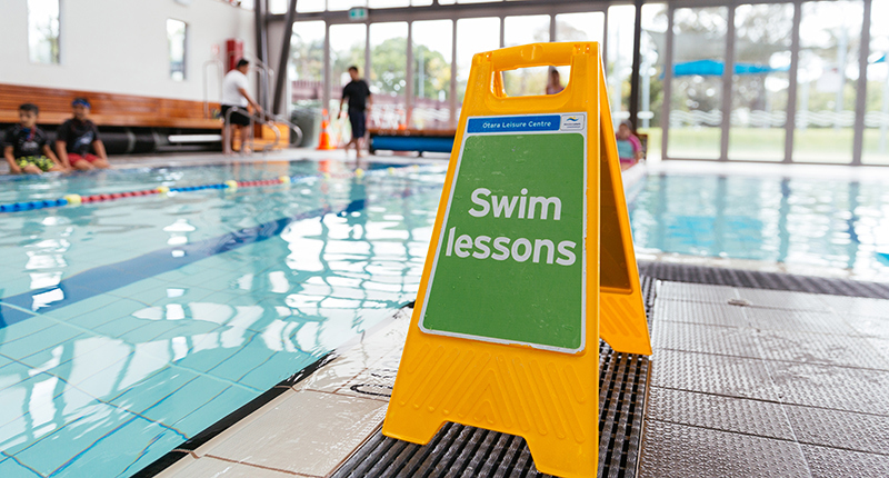 pool with swim lesson sign in foreground