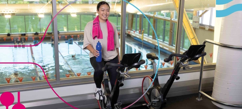 female riding stationary bike in gym